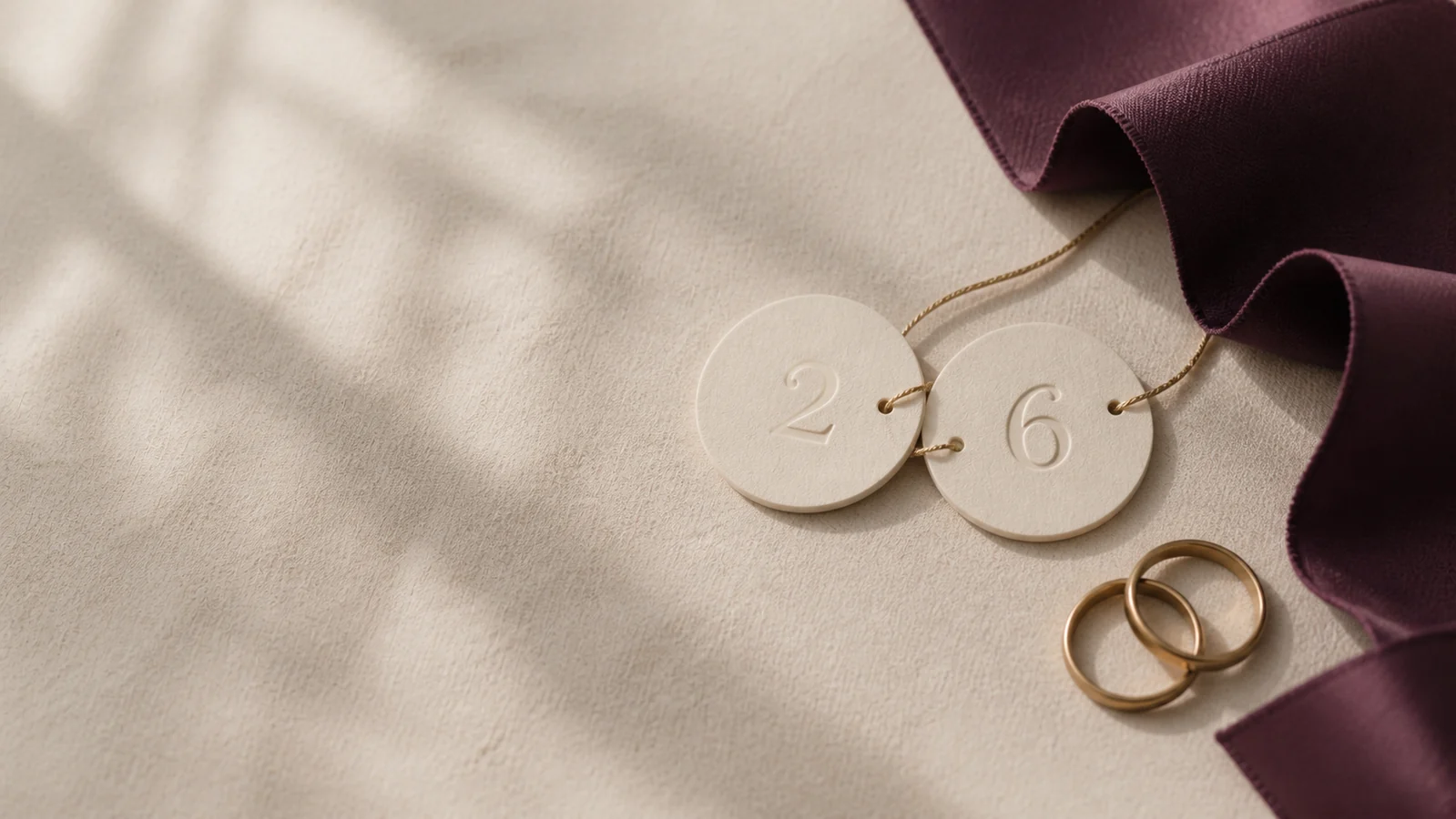 Two connected number discs and interlocking brass rings on ivory linen